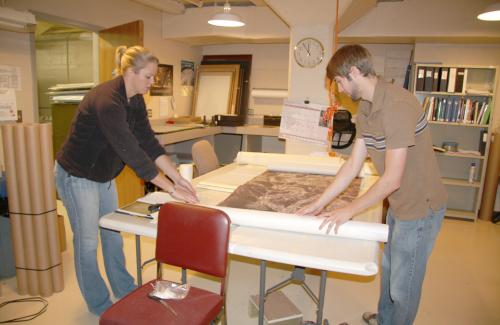 BHSU fall student interns Mallory Everett and Eric Somyak unpacking archival collections