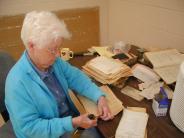 Catherine Ponce de Leon cleaning archival documents. 