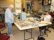 Volunteers Judy Farris and Helen Auer processing items from the Preacher Smith Heritage Center Collection