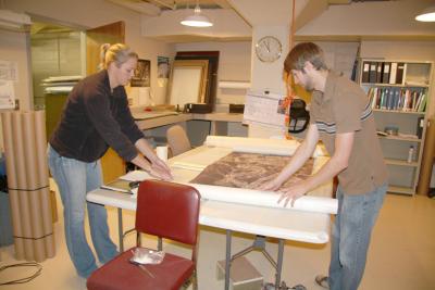 BHSU fall student interns Mallory Everett and Eric Somyak unpacking archival collections